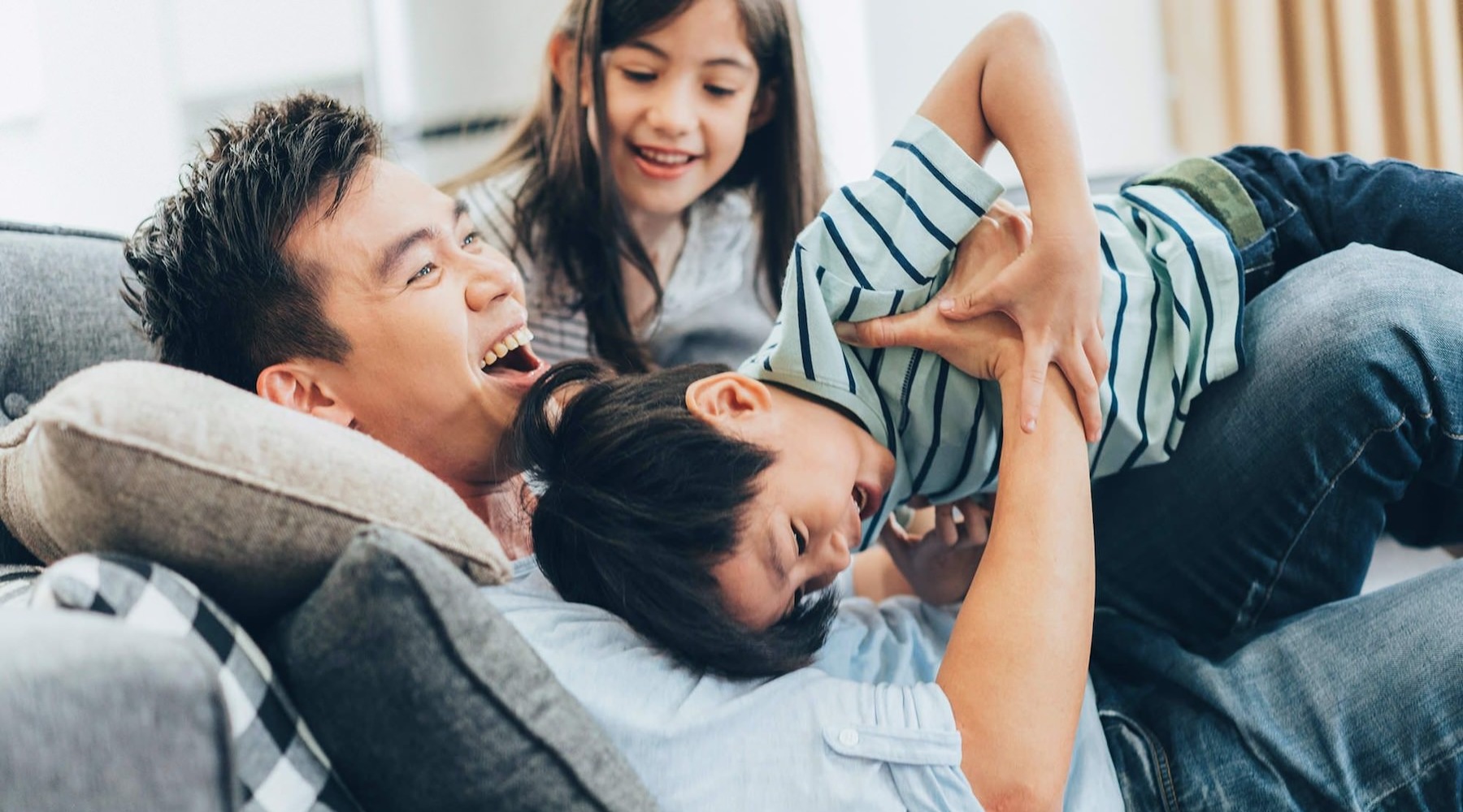 a family playing on a couch